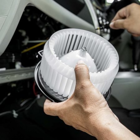 Technician in the service center install and maintenance blower air of car and use screwdriver remove a bolt in process,service concept